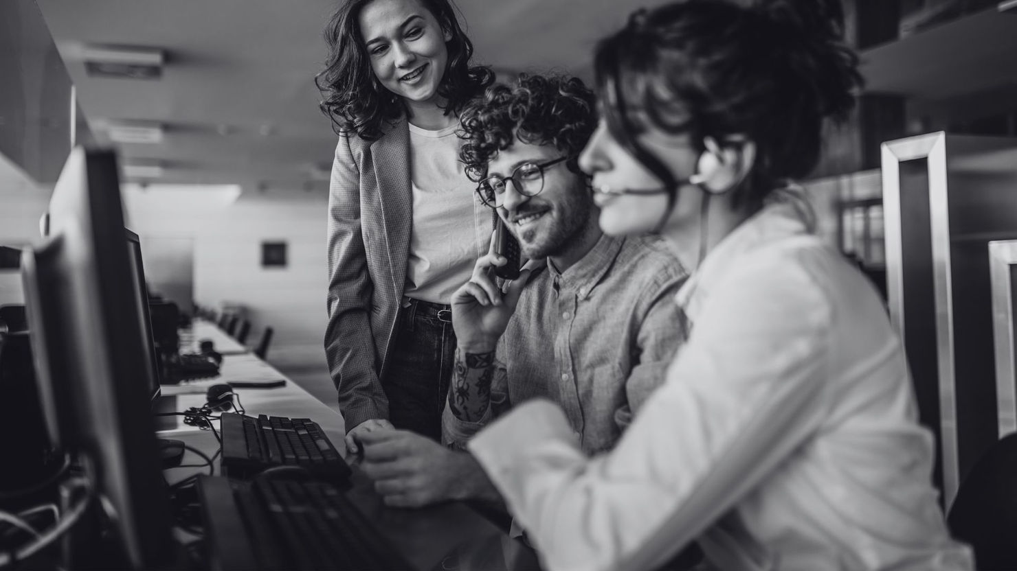 Team of IT support agents assisting client